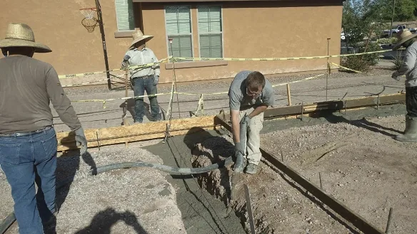 Concrete pump filling a residential footing form