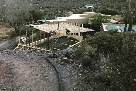 Concrete pump line running up a steep desert hillside